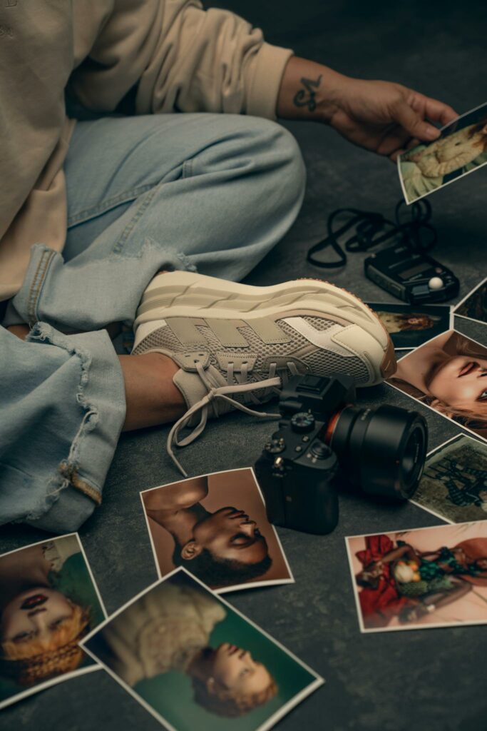 A creative display of various portrait photographs surrounded by photography equipment, evoking an artistic mood.