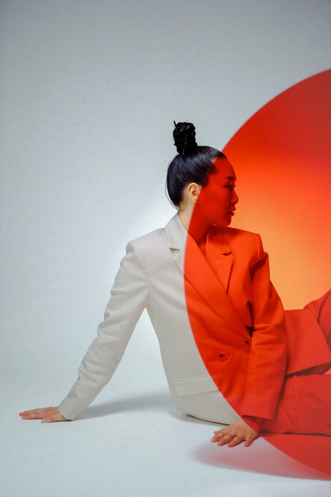 Stylish studio portrait of a woman with a unique artistic overlay, creating a modern and intriguing look.